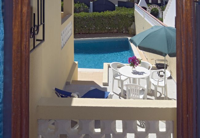 small terrace with pool small, side terrace of Villa Beatriz with white round table and chairs above the pool