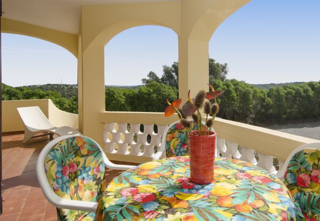 Dining table on the covered terrace on the upper floor Covered terrace on the upper floor of Villa Beatriz with a round dining table and colourful tablecloth