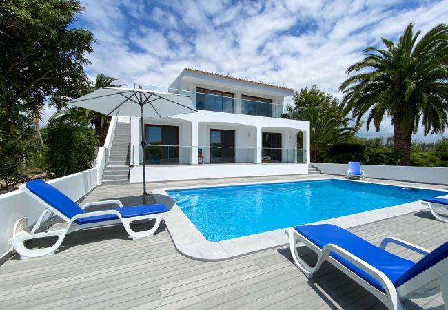 Villa Coruja pool with large terrace and blue deckchairs