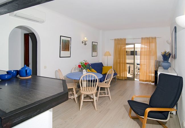 Living room with dining table and sofa Living room with round dining table for four and sofa in Casa Ana