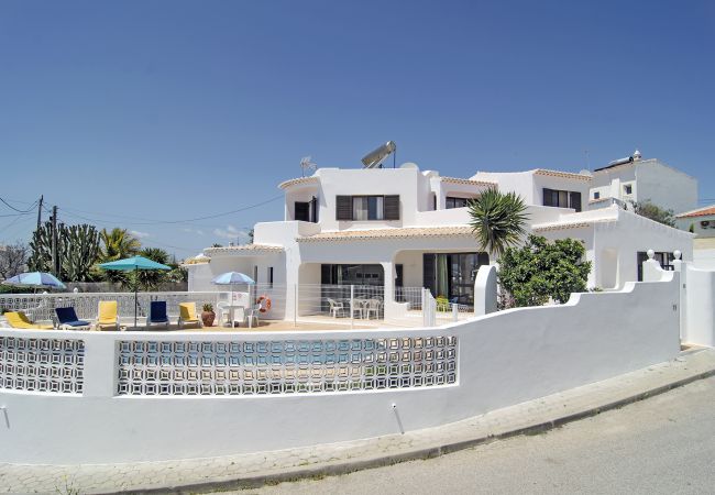 Villa Lobito enclosed pool area with sun loungers