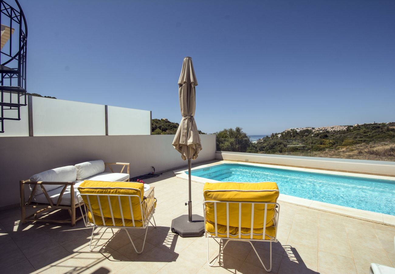 Sea view from the terrace with private pool Sea view from the private terrace of Villa Salemar with two yellow armchairs